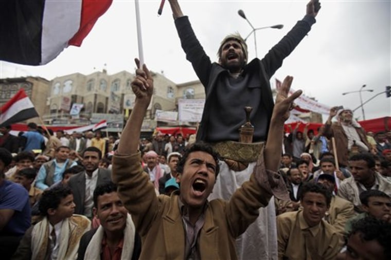 Anti-government protesters react during a demonstration demanding the resignation of Yemeni President Ali Abdullah Saleh, in Sanaa, Yemen, on Monday. Government supporters wielding knives and handguns attacked demonstrators in the country's south, leaving one dead in the latest of weeks of protests.